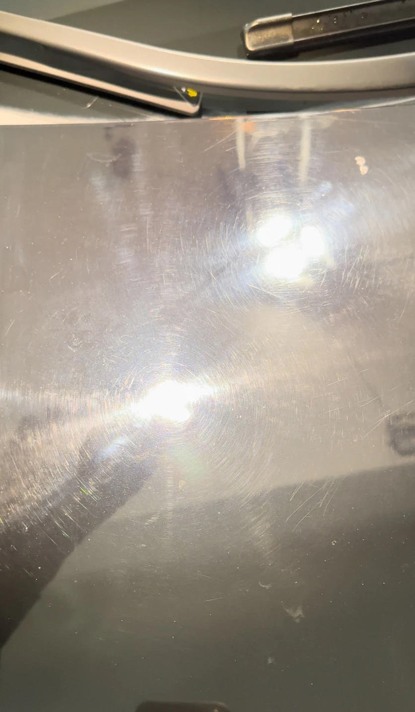 Vehicle paint before ceramic coating, showing heavy swirl marks and scratches
