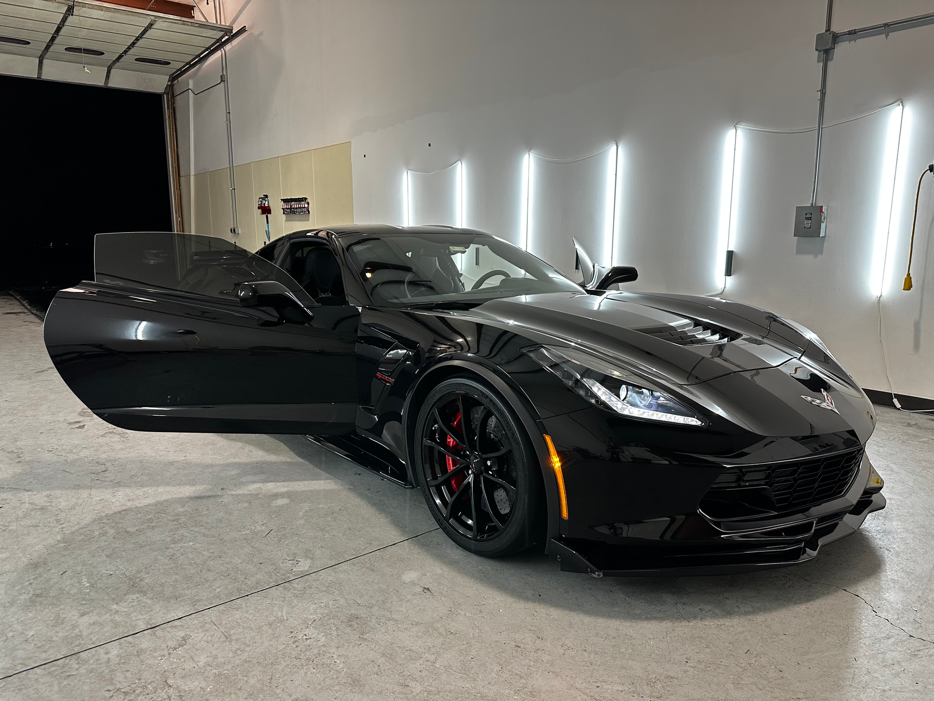 Glossy black Corvette with a fresh ceramic coating in the Detail Tech shop