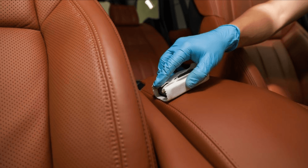 Detailer applying System X interior coating to leather seating