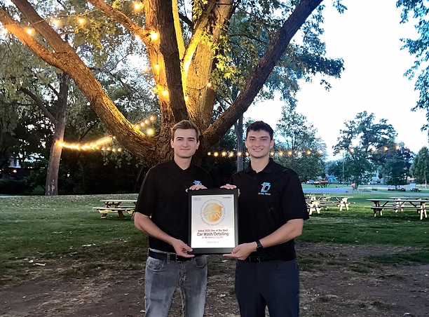 The Detail Tech owners holding their McHenry County Best award