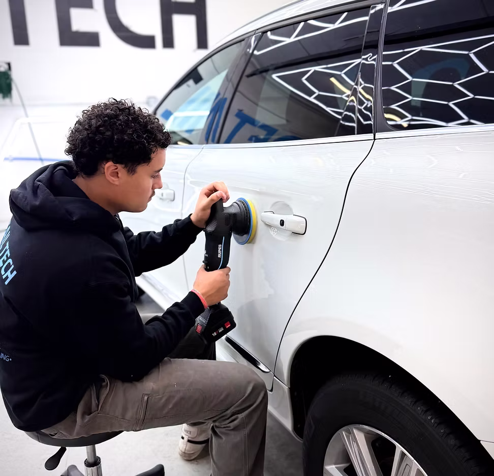 Detail Tech technician machine polishing a car during a 3-step paint correction