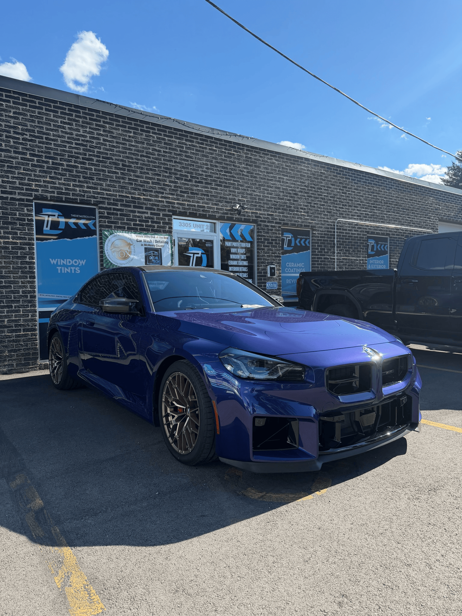 Blue BMW M2 after a Standard interior and exterior detail outside the Detail Tech shop