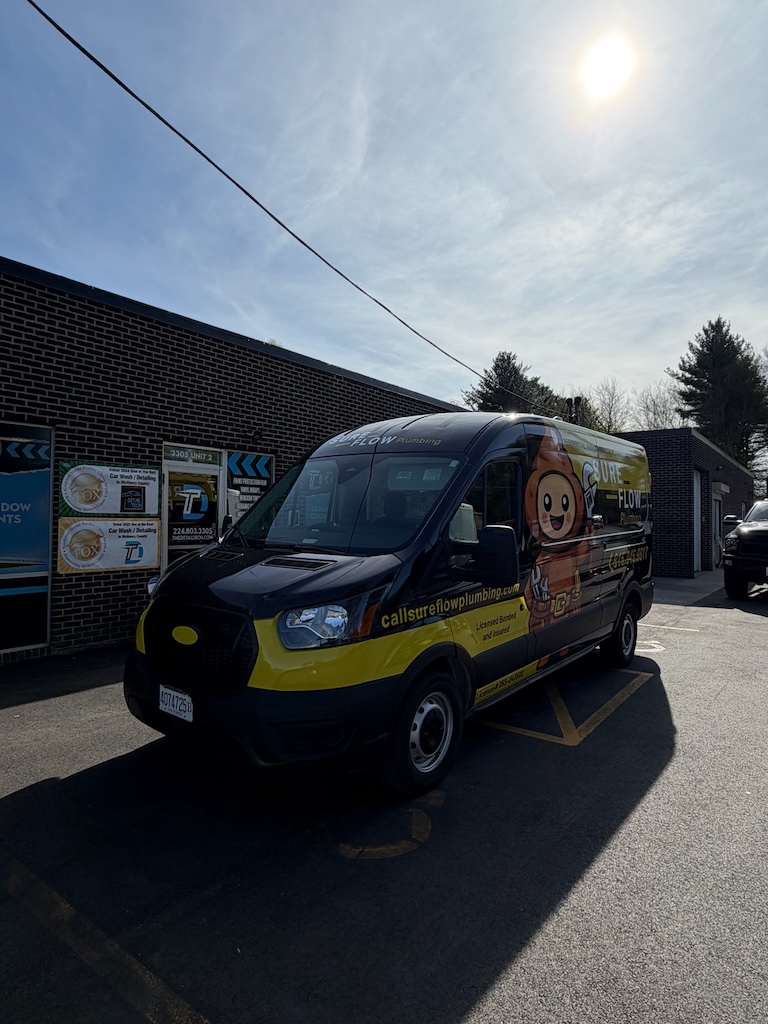 Sure Flow Plumbing van with a full commercial wrap outside the Detail Tech shop in Crystal Lake