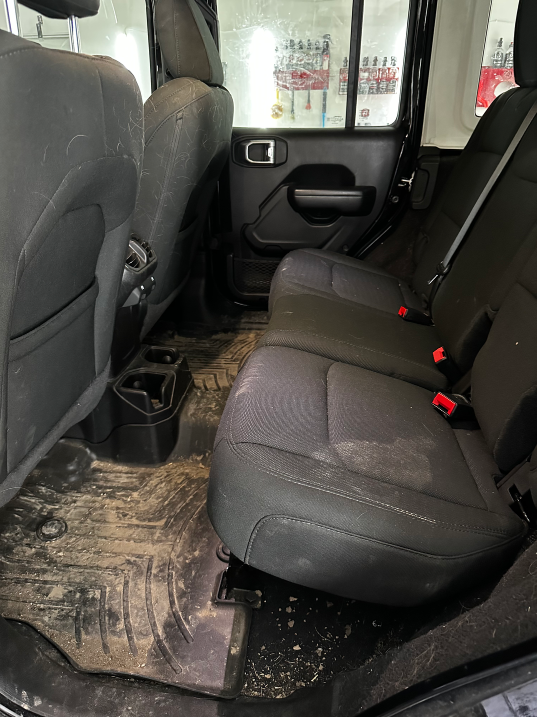 Jeep Wrangler rear seats before the Level 2 interior detail, showing dirt and debris