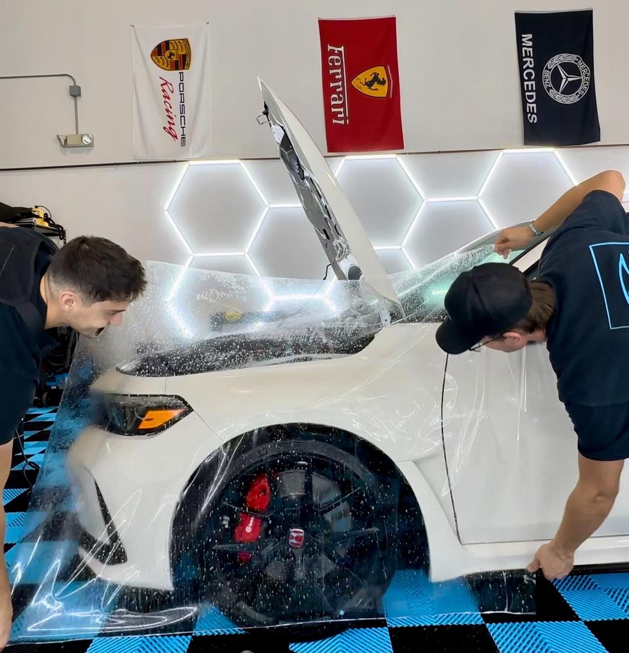 Paint protection film being installed on a car