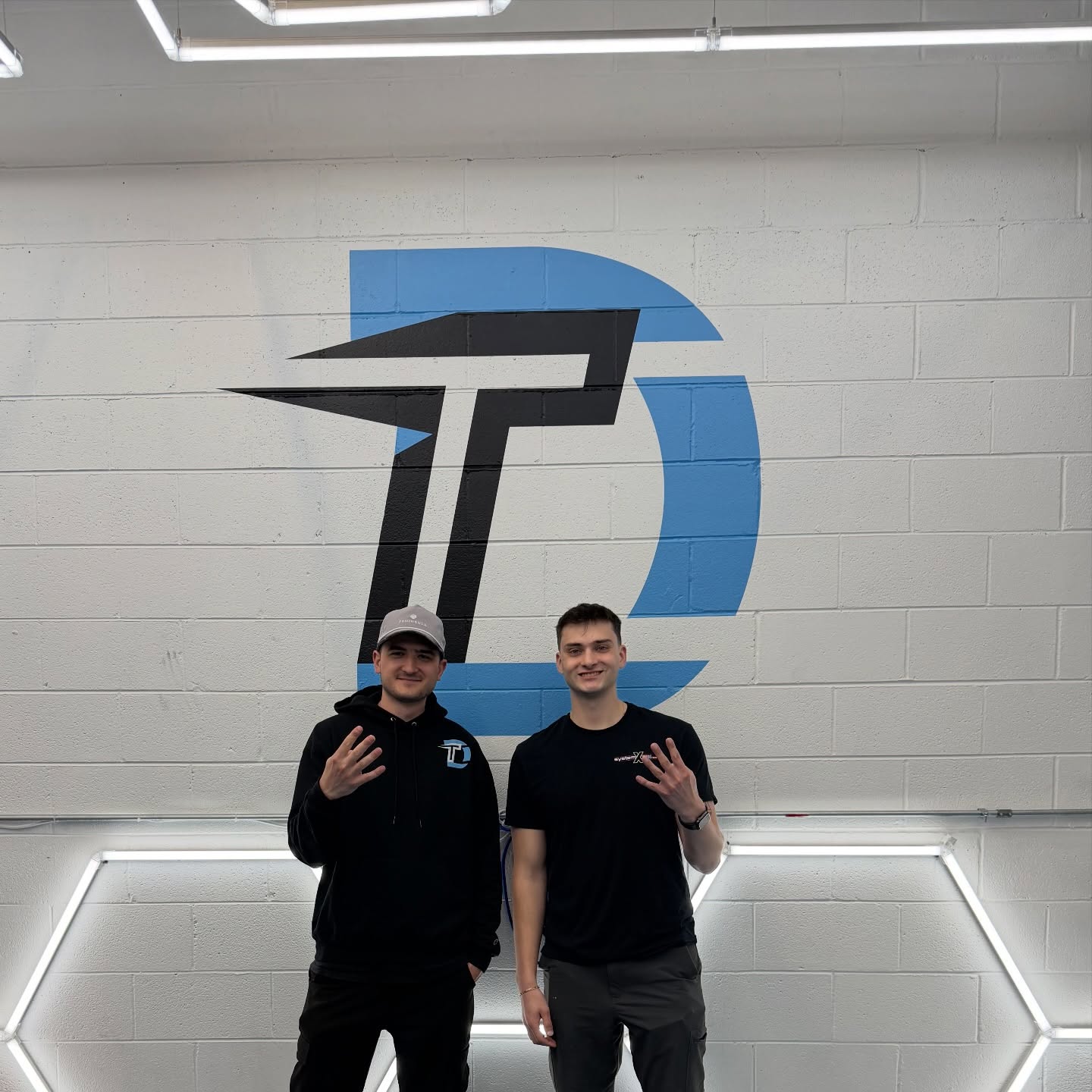 Dan and Kevin in front of the Detail Tech mural at the Crystal Lake shop