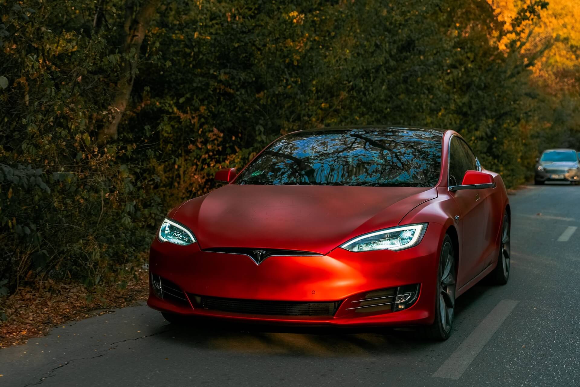 Glossy red Tesla Model 3 with a ceramic-coated finish