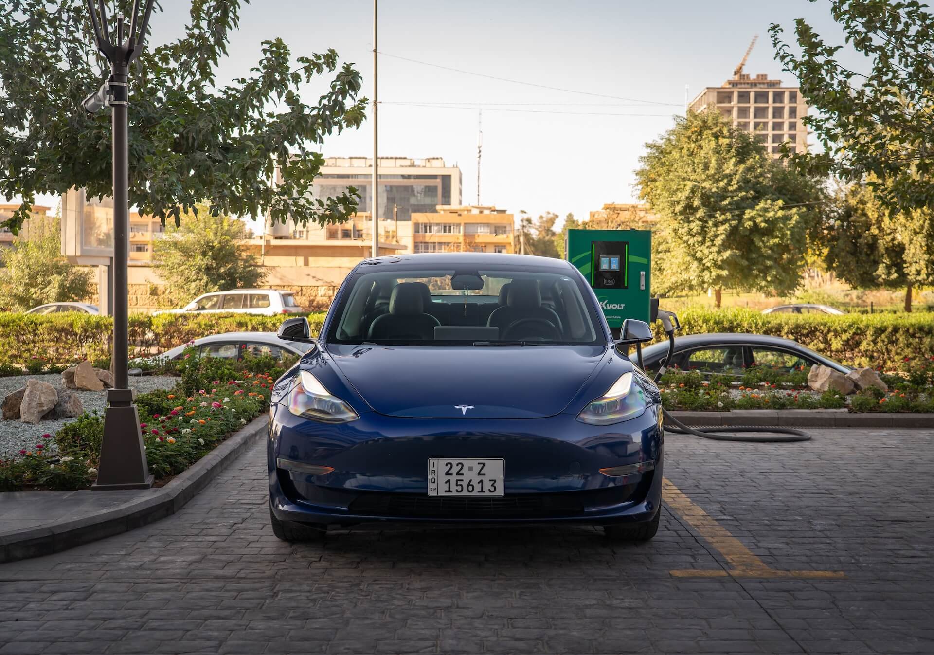 Blue Tesla Model 3 charging