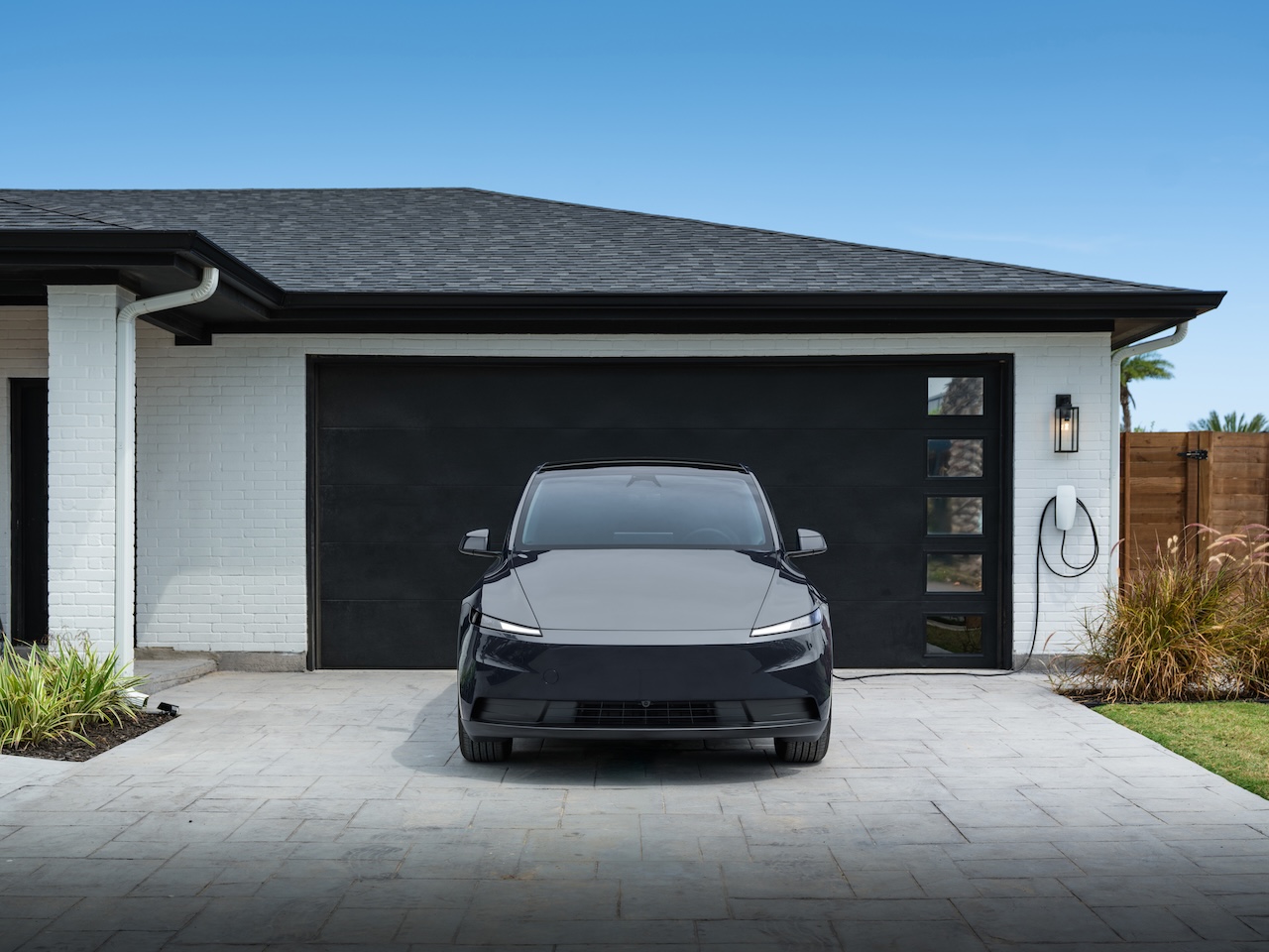 Tesla Model Y parked in a driveway with paint protection film