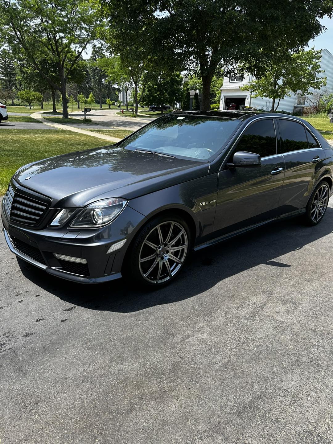Tinted grey Mercedes-Benz E63 AMG in the driveway