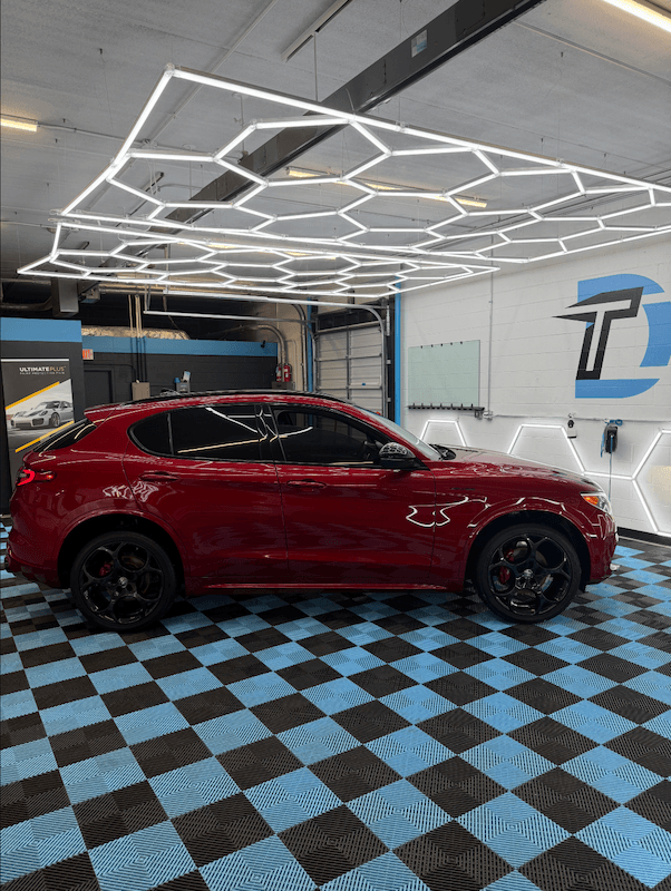 Full-vehicle window tint on a red Alfa Romeo Stelvio at Detail Tech