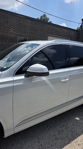 Two front windows tinted to match on a white sedan at Detail Tech